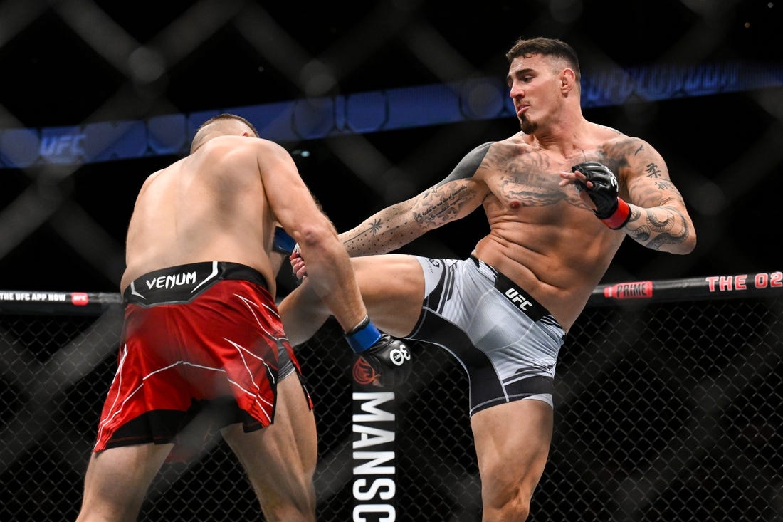 Jul 22, 2023; London, UNITED KINGDOM; Tom Aspinall (red gloves) fights Marcin Tybura (blue gloves) during UFC Fight Night at O2 Arena. Mandatory Credit: Per Haljestam-USA TODAY Sports