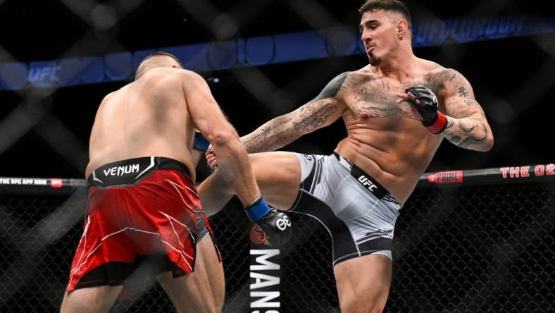 Jul 22, 2023; London, UNITED KINGDOM; Tom Aspinall (red gloves) fights Marcin Tybura (blue gloves) during UFC Fight Night at O2 Arena. Mandatory Credit: Per Haljestam-USA TODAY Sports