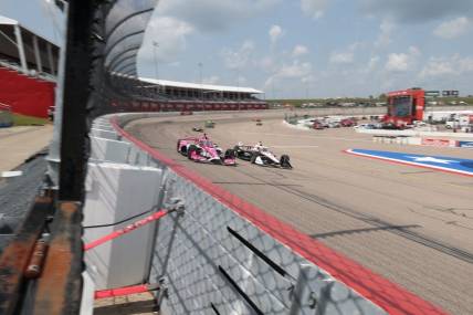 Jul 22, 2023; Newton, Iowa, USA; Team Penske driver Josef Newgarden (2) of United States and Meyer Shank Racing driver Conor Daly (60) of United States lead traffic down the front stretch during the Hy-Vee Homefront 250 at Iowa Speedway. Mandatory Credit: Reese Strickland-USA TODAY Sports