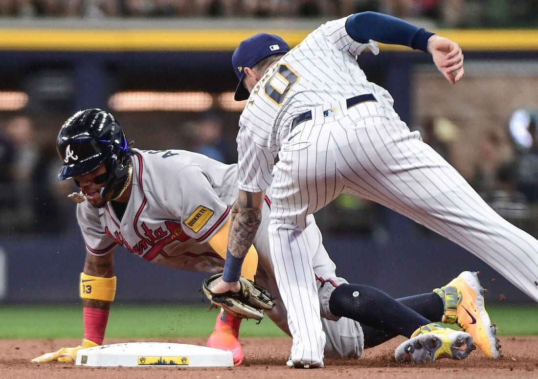Jul 22, 2023; Milwaukee, Wisconsin, USA; Atlanta Braves right fielder Ronald Acuna (13) steals second base before the tag by Milwaukee Brewers second baseman Brice Turang (0) in the first inning at American Family Field. Mandatory Credit: Benny Sieu-USA TODAY Sports