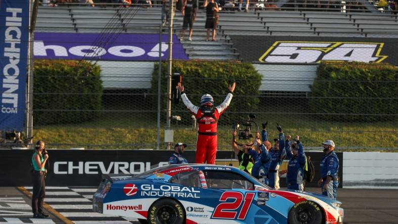 Jul 22, 2023; Long Pond, Pennsylvania, USA; NASCAR Xfinity Series driver Austin Hill (21) celebrates after winning the Explore The Pocono Mountains 225 at Pocono Raceway. Mandatory Credit: Matthew O'Haren-USA TODAY Sports