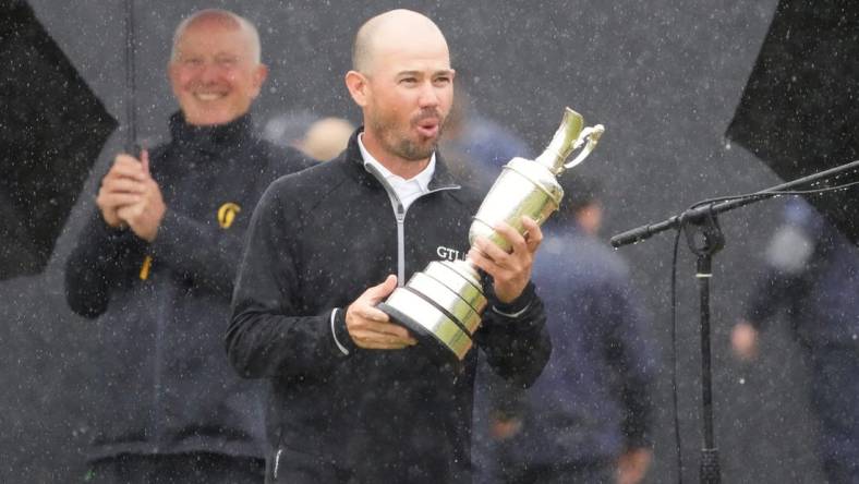 Jul 23, 2023; Hoylake, England, GBR; Brian Harman holds the Claret Jug after winning The Open Championship golf tournament. Mandatory Credit: Kyle Terada-USA TODAY Sports