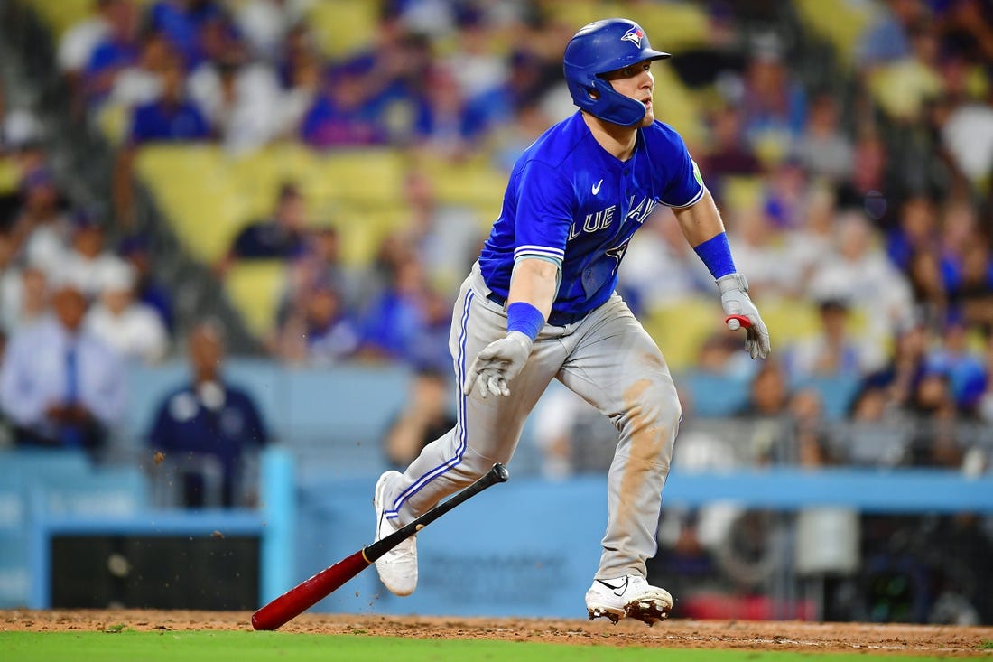 Jul 24, 2023; Los Angeles, California, USA; Toronto Blue Jays left fielder Daulton Varsho (25) hits a two run RBI double against the Los Angeles Dodgers during the eleventh inning  at Dodger Stadium. Mandatory Credit: Gary A. Vasquez-USA TODAY Sports