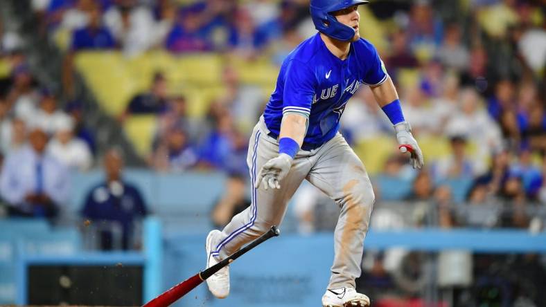 Jul 24, 2023; Los Angeles, California, USA; Toronto Blue Jays left fielder Daulton Varsho (25) hits a two run RBI double against the Los Angeles Dodgers during the eleventh inning  at Dodger Stadium. Mandatory Credit: Gary A. Vasquez-USA TODAY Sports