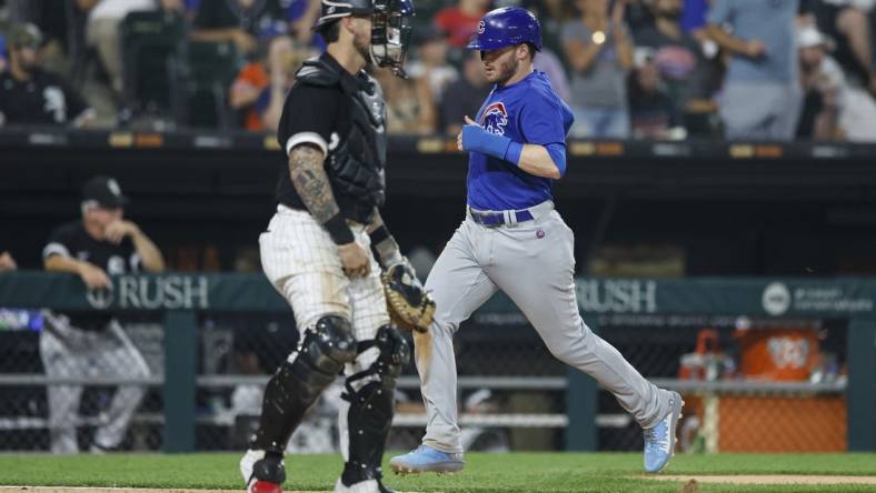 Jul 25, 2023; Chicago, Illinois, USA; Chicago Cubs left fielder Ian Happ (8) scores against the Chicago White Sox during the seventh inning at Guaranteed Rate Field. Mandatory Credit: Kamil Krzaczynski-USA TODAY Sports