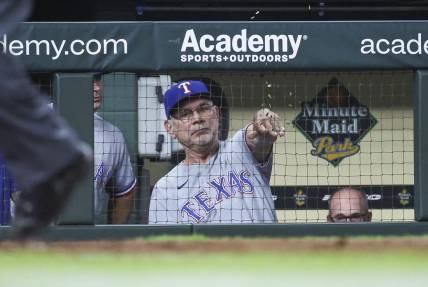 Jul 25, 2023; Houston, Texas, USA; Texas Rangers manager Bruce Bochy (15) throws seeds in the dugout after the results of a video review during the eighth inning against the Houston Astros at Minute Maid Park. Mandatory Credit: Troy Taormina-USA TODAY Sports