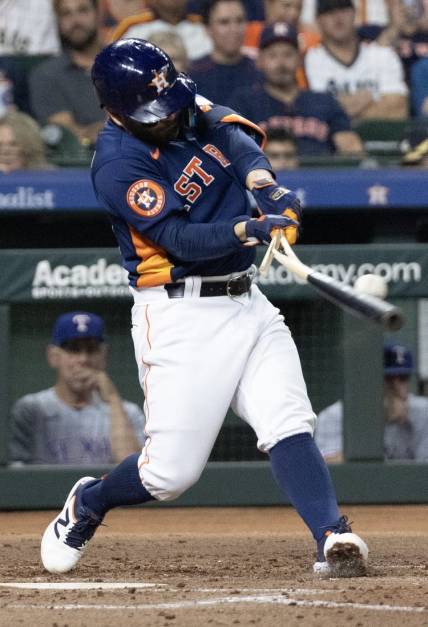 Jul 26, 2023; Houston, Texas, USA;  Houston Astros second baseman Jose Altuve (27) breaks his bat on a foul ball against the Texas Rangers in the third inning at Minute Maid Park. Mandatory Credit: Thomas Shea-USA TODAY Sports