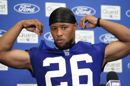 Jul 27, 2023; East Rutherford, NJ, USA;  New York Giants running back Saquon Barkley (26) fixes his jersey as he talks to reporters after day two of training camp at the Quest Diagnostics Training Facility. Mandatory Credit: Danielle Parhizkaran-USA TODAY Sports