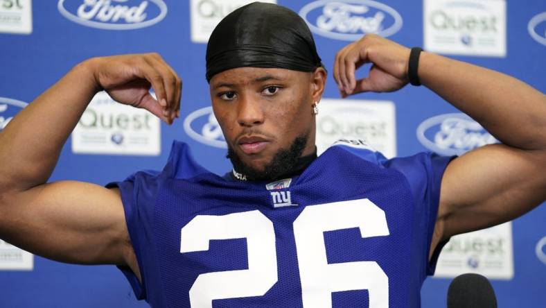 Jul 27, 2023; East Rutherford, NJ, USA;  New York Giants running back Saquon Barkley (26) fixes his jersey as he talks to reporters after day two of training camp at the Quest Diagnostics Training Facility. Mandatory Credit: Danielle Parhizkaran-USA TODAY Sports