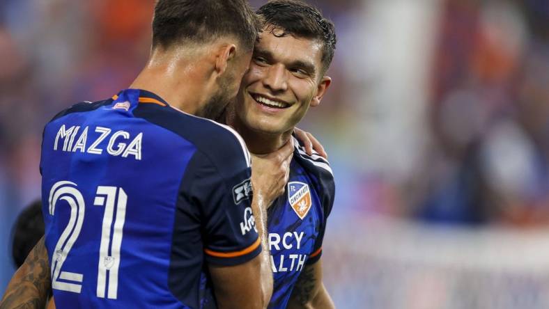 Jul 27, 2023; Cincinnati, OH, USA; FC Cincinnati forward Brandon Vazquez (19) reacts after scoring a goal with defender Matt Miazga (21) in the first half after the game at TQL Stadium. Mandatory Credit: Katie Stratman-USA TODAY Sports