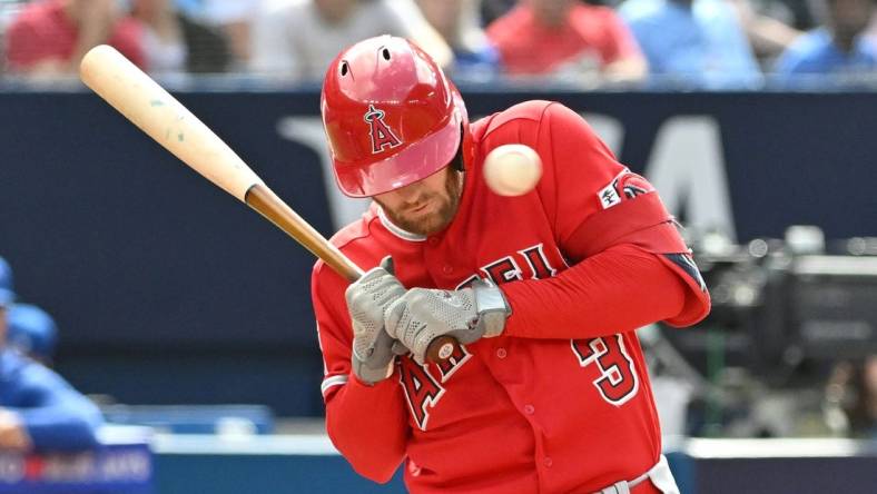 Jul 29, 2023; Toronto, Ontario, CAN; Los Angeles Angels left fielder Taylor Ward (3) is struck in the head by a pitch from Toronto Blue Jays pitcher Alek Manoah (not shown) in the fifth inning at Rogers Centre. Mandatory Credit: Dan Hamilton-USA TODAY Sports