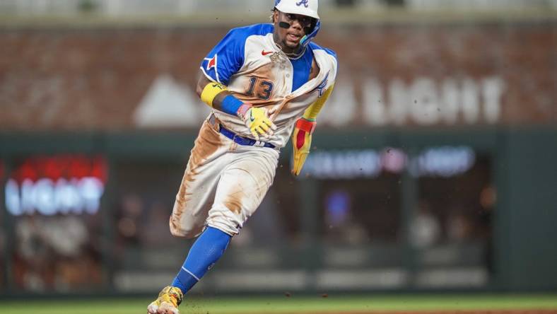 Jul 29, 2023; Cumberland, Georgia, USA; Atlanta Braves right fielder Ronald Acuna Jr. (13) runs against the Milwaukee Brewers during the eighth inning at Truist Park. Mandatory Credit: Dale Zanine-USA TODAY Sports