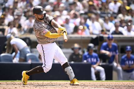 Jul 30, 2023; San Diego, California, USA; San Diego Padres catcher Gary Sanchez (99) hits a home run against the Texas Rangers during the fifth inning at Petco Park. Mandatory Credit: Orlando Ramirez-USA TODAY Sports