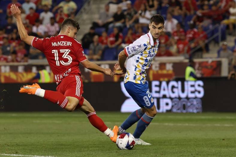 Jul 30, 2023; Harrison, NJ, USA; New York Red Bulls forward Dante Vanzeir (13) shoots the ball in front of Atletico De San Luis defender Pablo Martinez (28) during the second half at Red Bull Arena. Mandatory Credit: Vincent Carchietta-USA TODAY Sports
