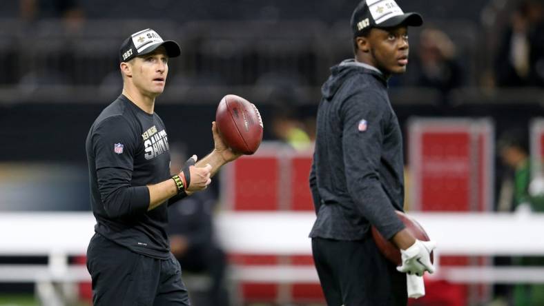 (File photo) New Orleans Saints quarterback Drew Brees (9) warms up before their game against the Arizona Cardinals at the Mercedes-Benz Superdome. Quarterback Teddy Bridgewater, right, looks on. Mandatory Credit: Chuck Cook-USA TODAY Sports