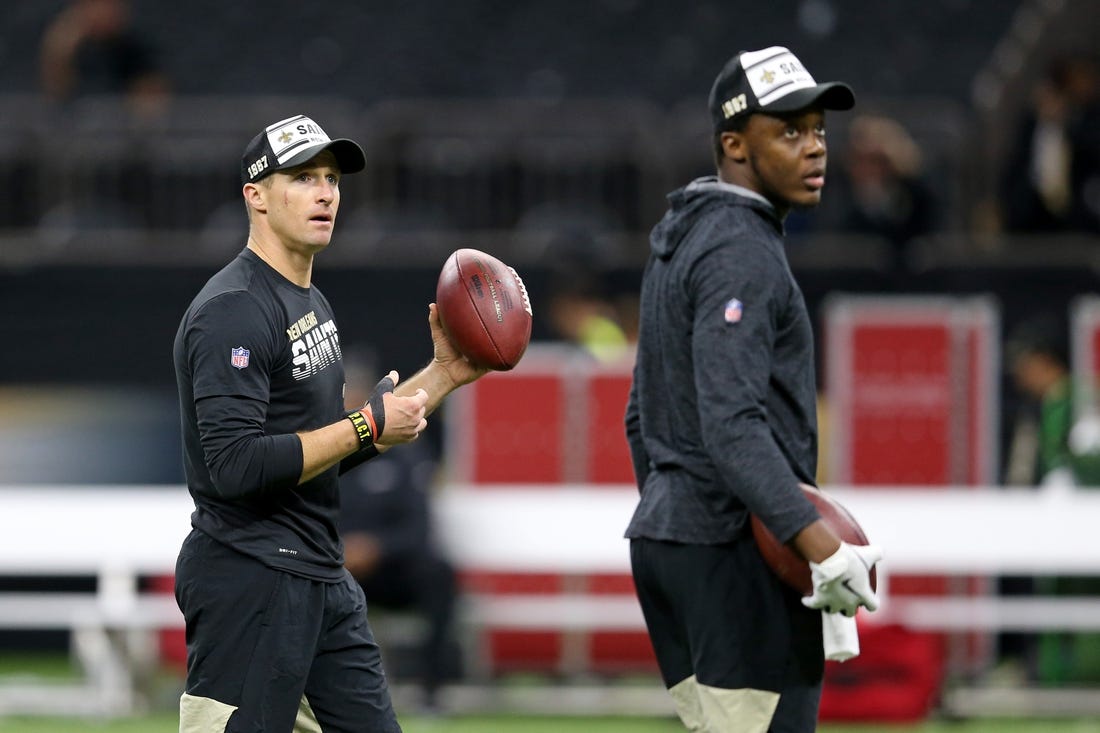 (File photo) New Orleans Saints quarterback Drew Brees (9) warms up before their game against the Arizona Cardinals at the Mercedes-Benz Superdome. Quarterback Teddy Bridgewater, right, looks on. Mandatory Credit: Chuck Cook-USA TODAY Sports