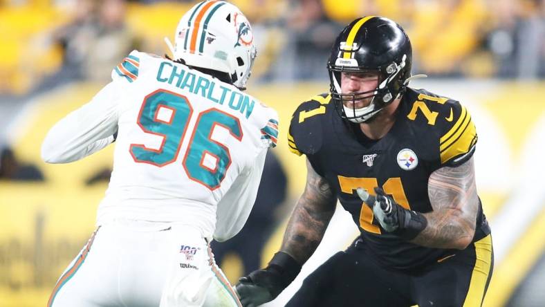 Oct 28, 2019; Pittsburgh, PA, USA;  Pittsburgh Steelers offensive tackle Matt Feiler (71) blocks at the line of scrimmage against Miami Dolphins defensive end Taco Charlton (96) during the second quarter at Heinz Field. The Steelers won 27-14. Mandatory Credit: Charles LeClaire-USA TODAY Sports