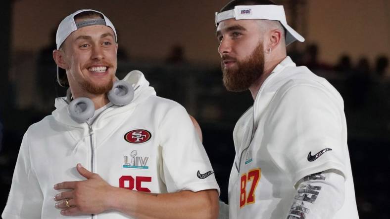 San Francisco 49ers tight end George Kittle (85) greets Kansas City Chiefs tight end Travis Kelce (87) during Super Bowl LIV Opening Night at Marlins Park.  Mandatory Credit: Kirby Lee-USA TODAY Sports