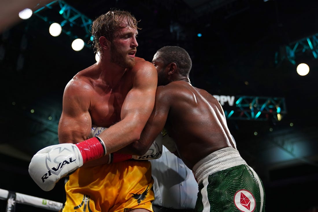 Jun 6, 2021; Miami, Florida, USA; Floyd Mayweather Jr. (Green Trunks) fights Logan Paul (Yellow Trunks) during an exhibition boxing match at Hard Rock Stadium. Mandatory Credit: Jasen Vinlove-USA TODAY Sports