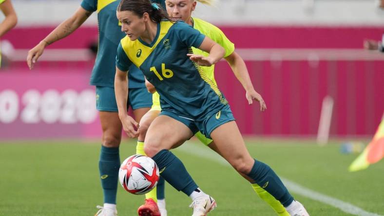 Jul 24, 2021; Saitama, Japan; Australia player Hayley Raso (16) moves the ball agains Sweden player Jonna Andersson (2) during the Tokyo 2020 Olympic Summer Games at Saitama Stadium. Mandatory Credit: Jack Gruber-USA TODAY Network