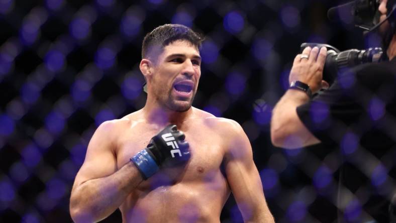 Aug 7, 2021; Houston, Texas, USA; Vicente Luque (blue gloves) reacts to the fight against Michael Chiesa (red gloves) during UFC 265 at Toyota Center. Mandatory Credit: Troy Taormina-USA TODAY Sports