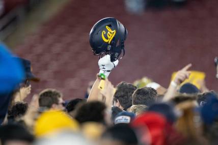 Nov 20, 2021; Stanford, California, USA; California Golden Bears helmet is raised into the air amongst fans after defeating the Stanford Cardinal at Stanford Stadium. Mandatory Credit: Stan Szeto-USA TODAY Sports