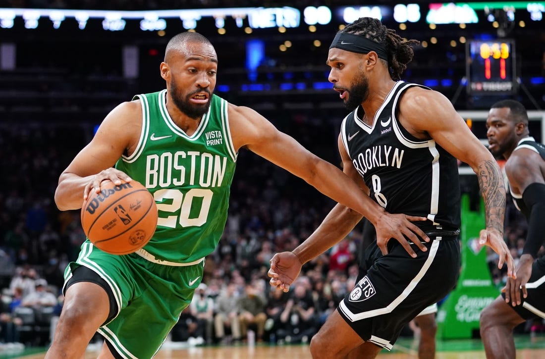 Nov 24, 2021; Boston, Massachusetts, USA; Boston Celtics forward Jabari Parker (20) drives the ball against Brooklyn Nets guard Patty Mills (8) in the second half at TD Garden. Mandatory Credit: David Butler II-USA TODAY Sports