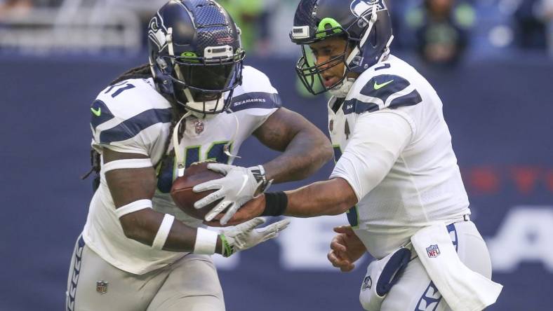 Dec 12, 2021; Houston, Texas, USA; Seattle Seahawks quarterback Russell Wilson (3) hands the ball to Seattle Seahawks running back Alex Collins (41) against the Houston Texans at NRG Stadium. Mandatory Credit: Thomas Shea-USA TODAY Sports