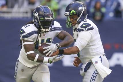 Dec 12, 2021; Houston, Texas, USA; Seattle Seahawks quarterback Russell Wilson (3) hands the ball to Seattle Seahawks running back Alex Collins (41) against the Houston Texans at NRG Stadium. Mandatory Credit: Thomas Shea-USA TODAY Sports
