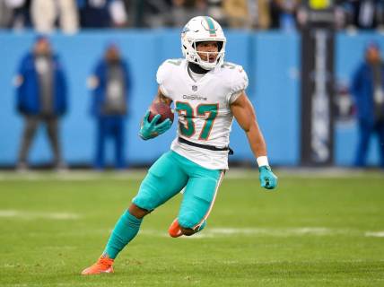 Jan 2, 2022; Nashville, Tennessee, USA;  Miami Dolphins running back Myles Gaskin (37) runs the ball against the Tennessee Titans during the first half at Nissan Stadium. Mandatory Credit: Steve Roberts-USA TODAY Sports