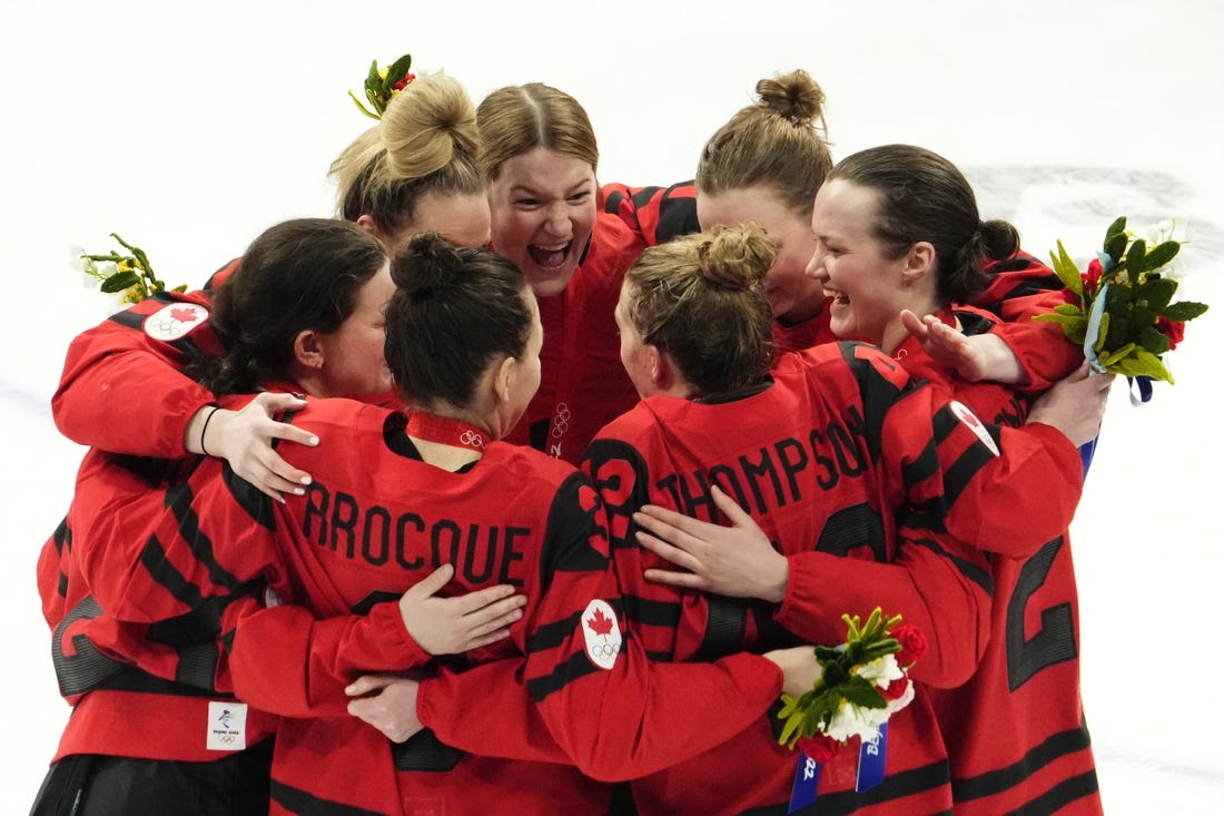 Feb 17, 2022; Beijing, China; Team Canada players celebrate after the medals ceremony during the Beijing 2022 Olympic Winter Games at Wukesong Sports Centre. Mandatory Credit: Rob Schumacher-USA TODAY Sports