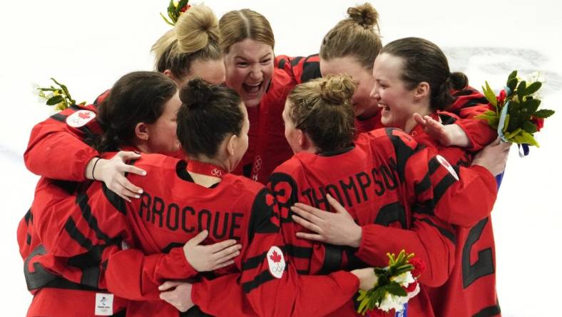 Feb 17, 2022; Beijing, China; Team Canada players celebrate after the medals ceremony during the Beijing 2022 Olympic Winter Games at Wukesong Sports Centre. Mandatory Credit: Rob Schumacher-USA TODAY Sports