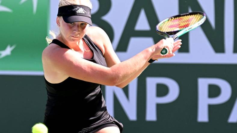 Mar 13, 2022; Indian Wells, CA, USA; Clara Tauson (DEN) hits a shot during her third round match against  Iga Swiatek (POL)at the BNP Paribas Open at the Indian Wells Tennis Garden. Mandatory Credit: Jayne Kamin-Oncea-USA TODAY Sports