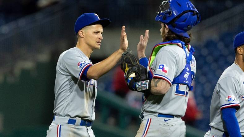 May 3, 2022; Philadelphia, Pennsylvania, USA; Texas Rangers shortstop Corey Seager (5) and catcher Jonah Heim (28) high five after a victory against the Philadelphia Phillies at Citizens Bank Park. Mandatory Credit: Bill Streicher-USA TODAY Sports