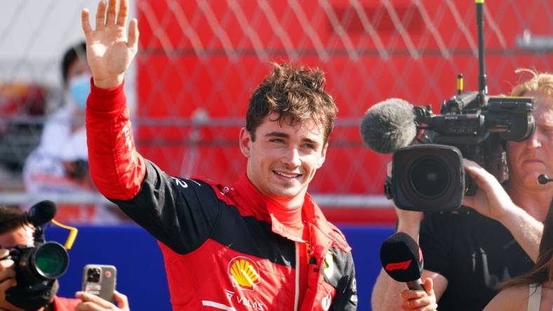 May 7, 2022; Miami Gardens, Florida, USA; Ferrari driver Charles Leclerc of Monaco waves to the fans in the stands after winning the pole position following qualifying for the Miami Grand Prix at Miami International Autodrome. Mandatory Credit: John David Mercer-USA TODAY Sports