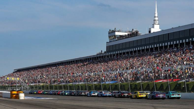 Jul 24, 2022; Long Pond, Pennsylvania, USA; NASCAR Cup Series driver Kyle Busch (18) leads the field on a restart during the M&M   S Fan Appreciation 400 at Pocono Raceway. Mandatory Credit: Matthew OHaren-USA TODAY Sports