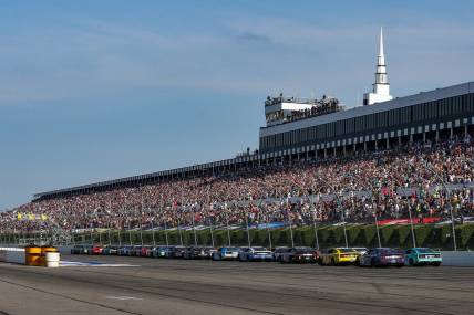 Jul 24, 2022; Long Pond, Pennsylvania, USA; NASCAR Cup Series driver Kyle Busch (18) leads the field on a restart during the M&M   S Fan Appreciation 400 at Pocono Raceway. Mandatory Credit: Matthew OHaren-USA TODAY Sports