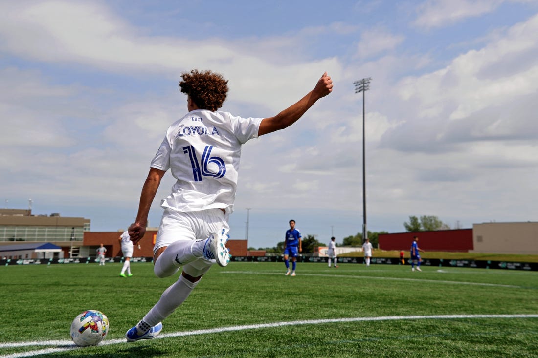 Aug 10, 2022; Blaine, MN, USA; MLS Next East player Favian Loyola (16) of Orlando City takes a corner kick against MLS Next West during the second half of the 2022 MLS NEXT All-Star Game at National Sports Center Indoor Sports Hall. Mandatory Credit: Kirby Lee-USA TODAY Sports