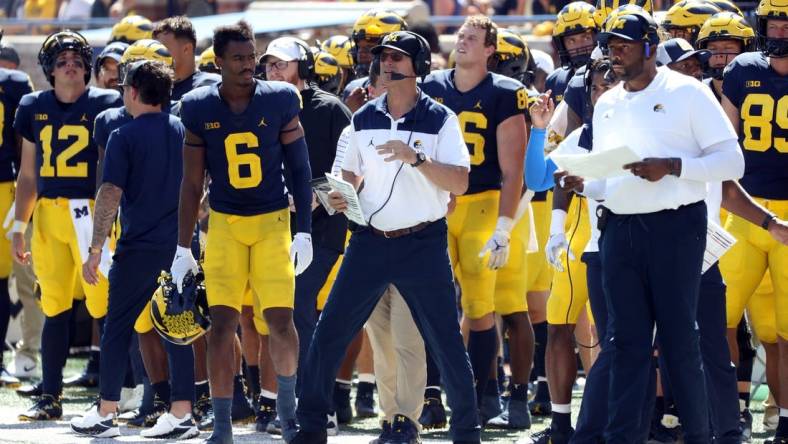 Michigan Wolverines head coach Jim Harbaugh and offensive coordinator Sherrone Moore, pictured during 

Michigan's 2022 season opener.