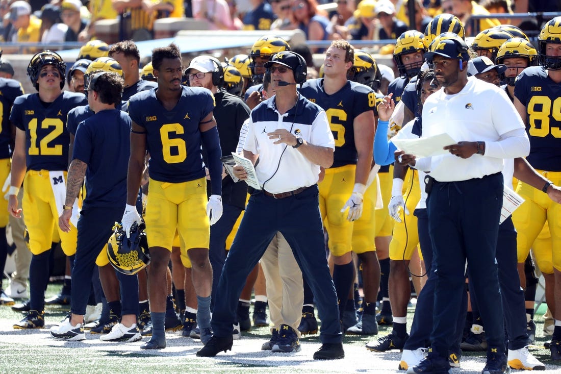 Michigan Wolverines head coach Jim Harbaugh and offensive coordinator Sherrone Moore, pictured during 

Michigan's 2022 season opener.