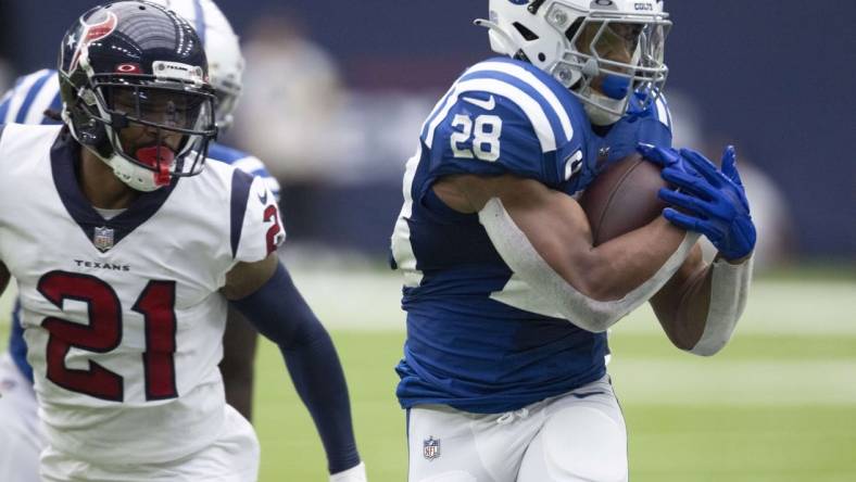 Sep 11, 2022; Houston, Texas, USA; Indianapolis Colts running back Jonathan Taylor (28) rushes against Houston Texans cornerback Steven Nelson (21) in the first quarter at NRG Stadium. Mandatory Credit: Thomas Shea-USA TODAY Sports