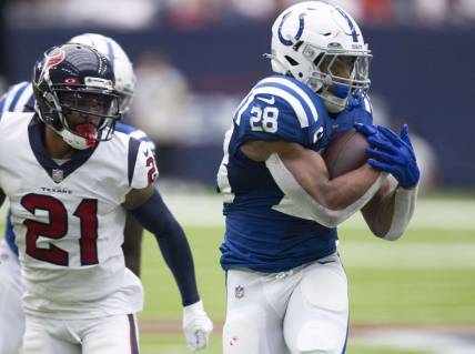 Sep 11, 2022; Houston, Texas, USA; Indianapolis Colts running back Jonathan Taylor (28) rushes against Houston Texans cornerback Steven Nelson (21) in the first quarter at NRG Stadium. Mandatory Credit: Thomas Shea-USA TODAY Sports