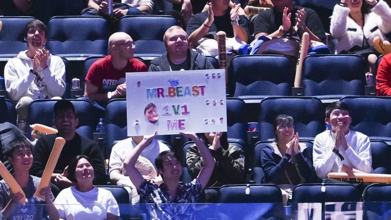 Nov 5, 2022; San Francisco, California, USA; A fan holds a sign during the League of Legends World Championships between T1 and DRX at Chase Center. Mandatory Credit: Kelley L Cox-USA TODAY Sports