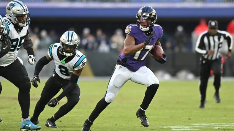 Nov 20, 2022; Baltimore, Maryland, USA; Baltimore Ravens running back Kenyan Drake (17) rushes by Carolina Panthers cornerback Jaycee Horn (8) during the second half  at M&T Bank Stadium. Mandatory Credit: Tommy Gilligan-USA TODAY Sports