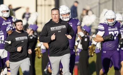 Nov 26, 2022; Evanston, Illinois, USA; Northwestern Wildcats head coach Pat Fitzgerald leads his team on the field against the Illinois Fighting Illini at Ryan Field. Mandatory Credit: David Banks-USA TODAY Sports