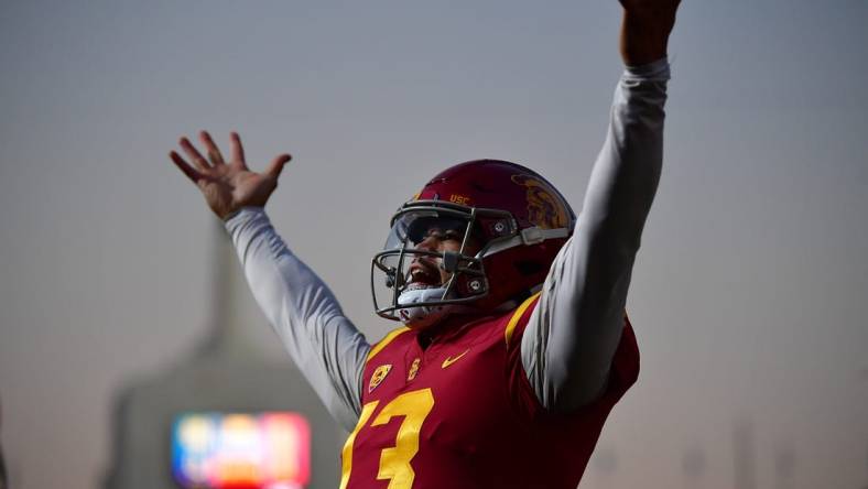 Southern California Trojans quarterback Caleb Williams (13) celebrates Tahj Washington (16) scoring a touchdown against the Notre Dame Fighting Irish during the first half at the Los Angeles Memorial Coliseum. Mandatory Credit: Gary A. Vasquez-USA TODAY Sports