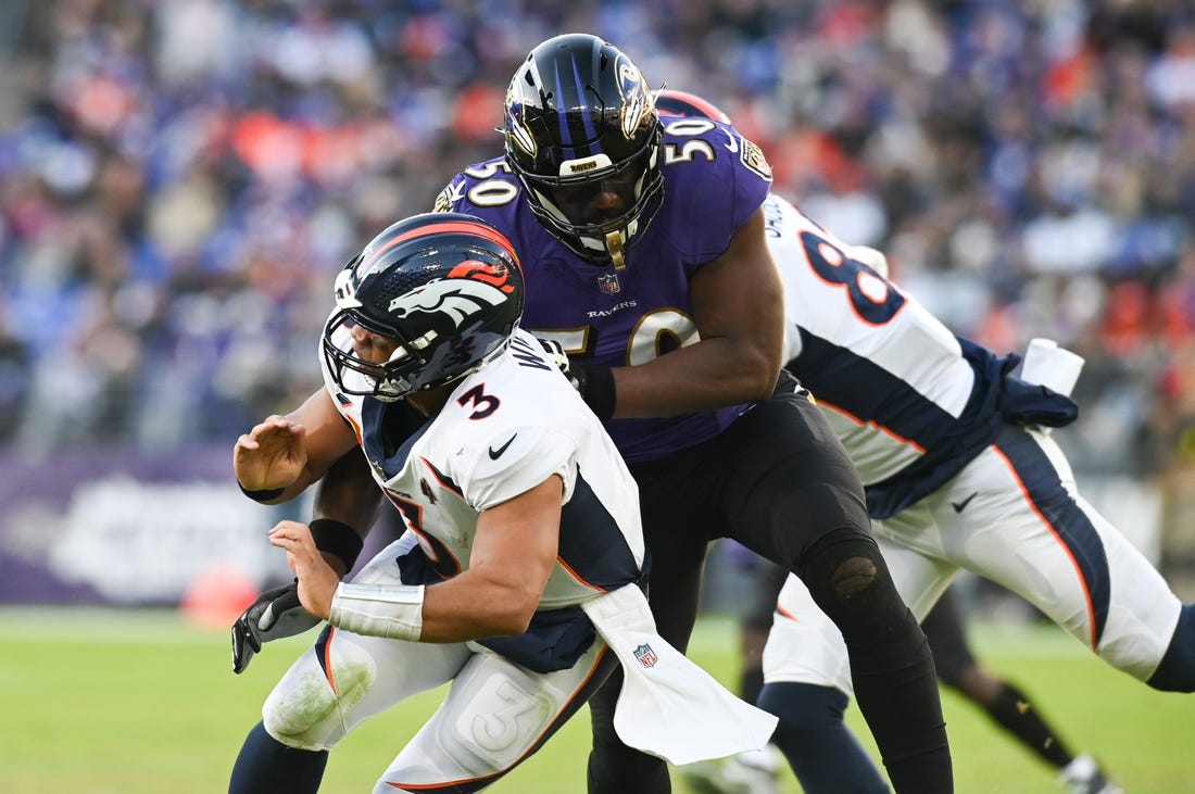 Dec 4, 2022; Baltimore, Maryland, USA;Baltimore Ravens linebacker Justin Houston (50) hits Denver Broncos quarterback Russell Wilson (3)  during the second half  at M&T Bank Stadium. Mandatory Credit: Tommy Gilligan-USA TODAY Sports