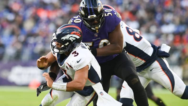 Dec 4, 2022; Baltimore, Maryland, USA;Baltimore Ravens linebacker Justin Houston (50) hits Denver Broncos quarterback Russell Wilson (3)  during the second half  at M&T Bank Stadium. Mandatory Credit: Tommy Gilligan-USA TODAY Sports