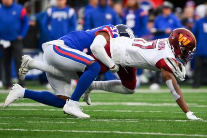 Dec 4, 2022; East Rutherford, New Jersey, USA; Washington Commanders wide receiver Terry McLaurin (17) dives for extra yards while being tackled by New York Giants cornerback Fabian Moreau (37) during the second half at MetLife Stadium. Mandatory Credit: Rich Barnes-USA TODAY Sports
