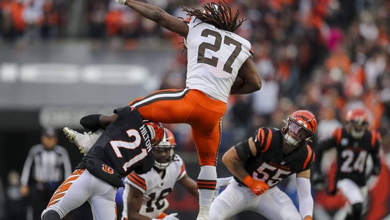 Dec 11, 2022; Cincinnati, Ohio, USA; Cincinnati Bengals cornerback Mike Hilton (21) brings down Cleveland Browns running back Kareem Hunt (27) in the second half at Paycor Stadium. Mandatory Credit: Katie Stratman-USA TODAY Sports